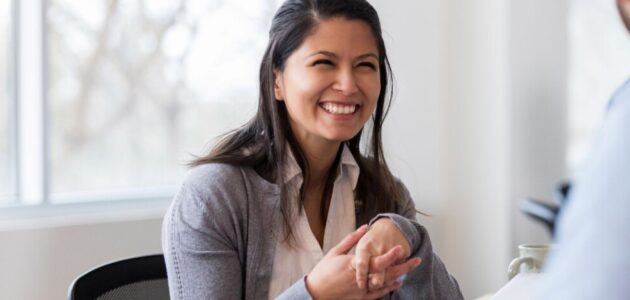 Woman chatting at a table with another employee