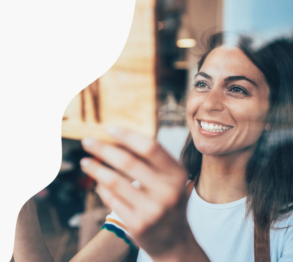 QSEHRA small business owner putting up an Open sign